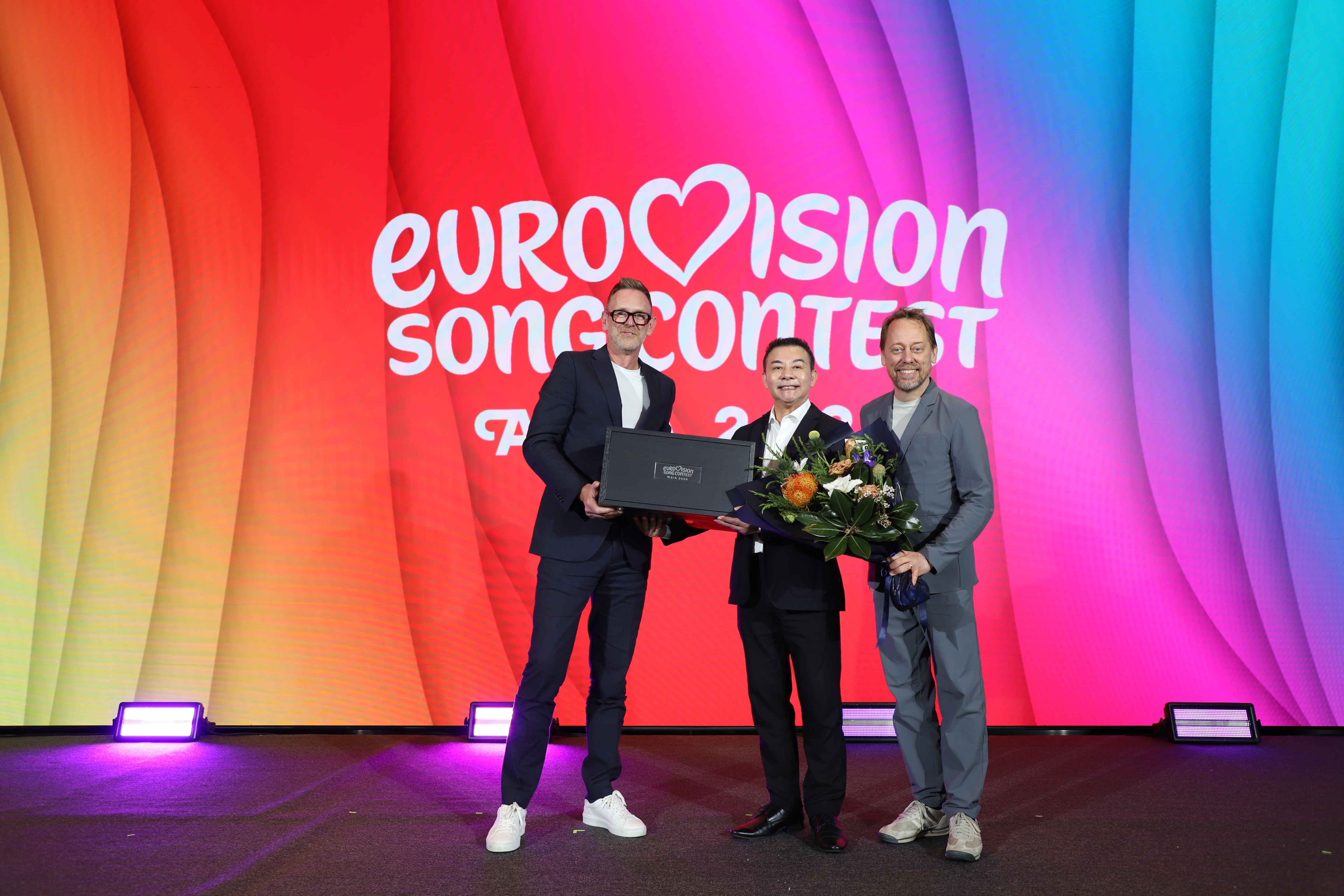 Martin Green, Director of Eurovision Song Contest (left) presents the Eurovision Song Contest Asia 2026 trophy to Chuwit Sirivajjakul, Deputy Governor for Policy and Planning, Tourism Authority Thailand (centre) for safekeeping on behalf of host city Bangkok until the Grand Final in November, accompanied by Peter Settman, CEO & Co-Founder of Voxovation (right).