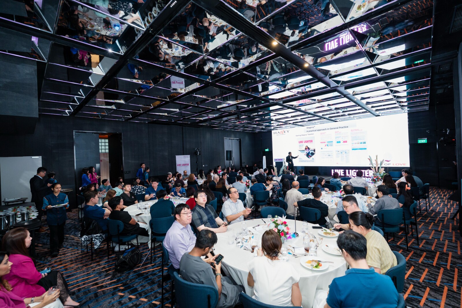Dr. Terence Tan presenting at a symposium, sharing insights on medical weight management in Singapore and the use of GLP-1 receptor agonists (GLP-1 RAs), including patient selection and common clinical challenges.
