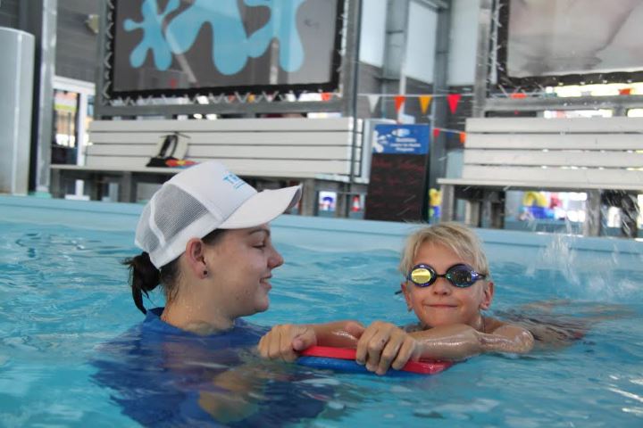 Tweed Regional Aquatic Centre learn to swim instructor Gemma Bright with Zayne Chisholm.